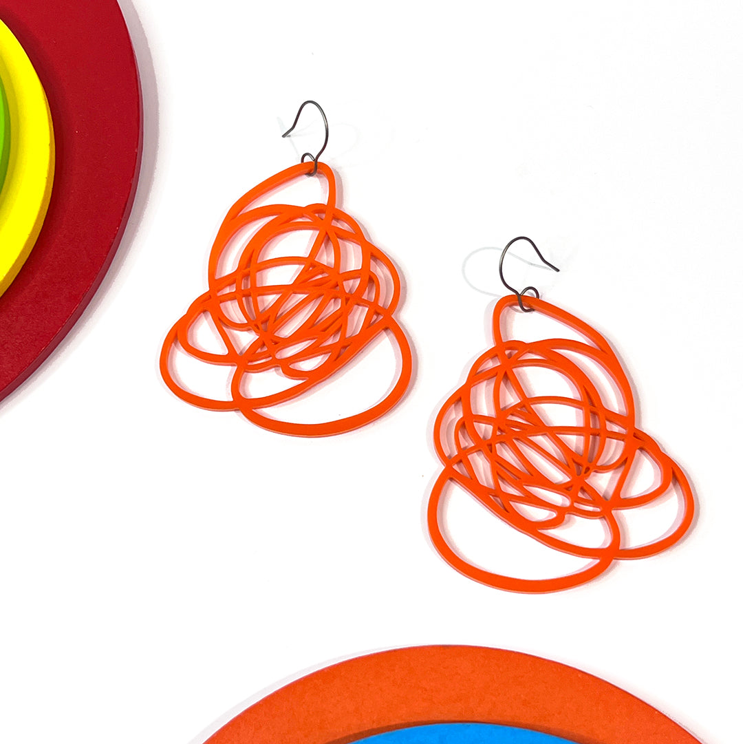 Colorful and bold acrylic doodle earrings in bright orange from by Barbe Jewelry. Be art - wear art.