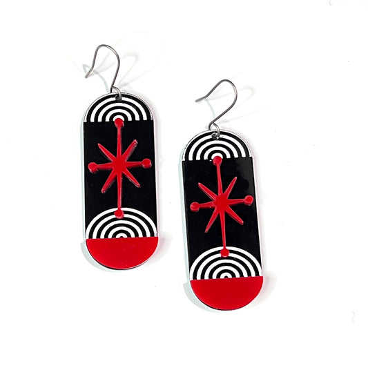 Bold and edgy black, white and red atomic starburst acrylic earrings by Barbe Saint John.