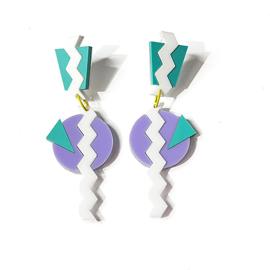 Close up of lavender, aqua and white 80's Memphis dangle earrings from by Barbe Jewelry.